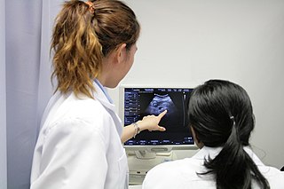 Diagnostic medical sonographer pointing at an ultrasound