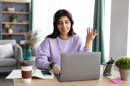 young woman participating in an online college class - best free online colleges in Massachusetts