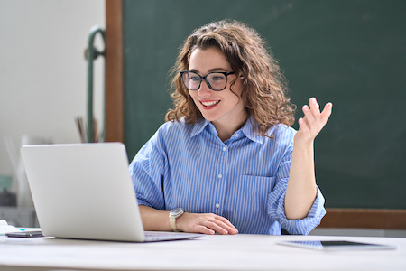 young woman participating in her online class on her laptop computer